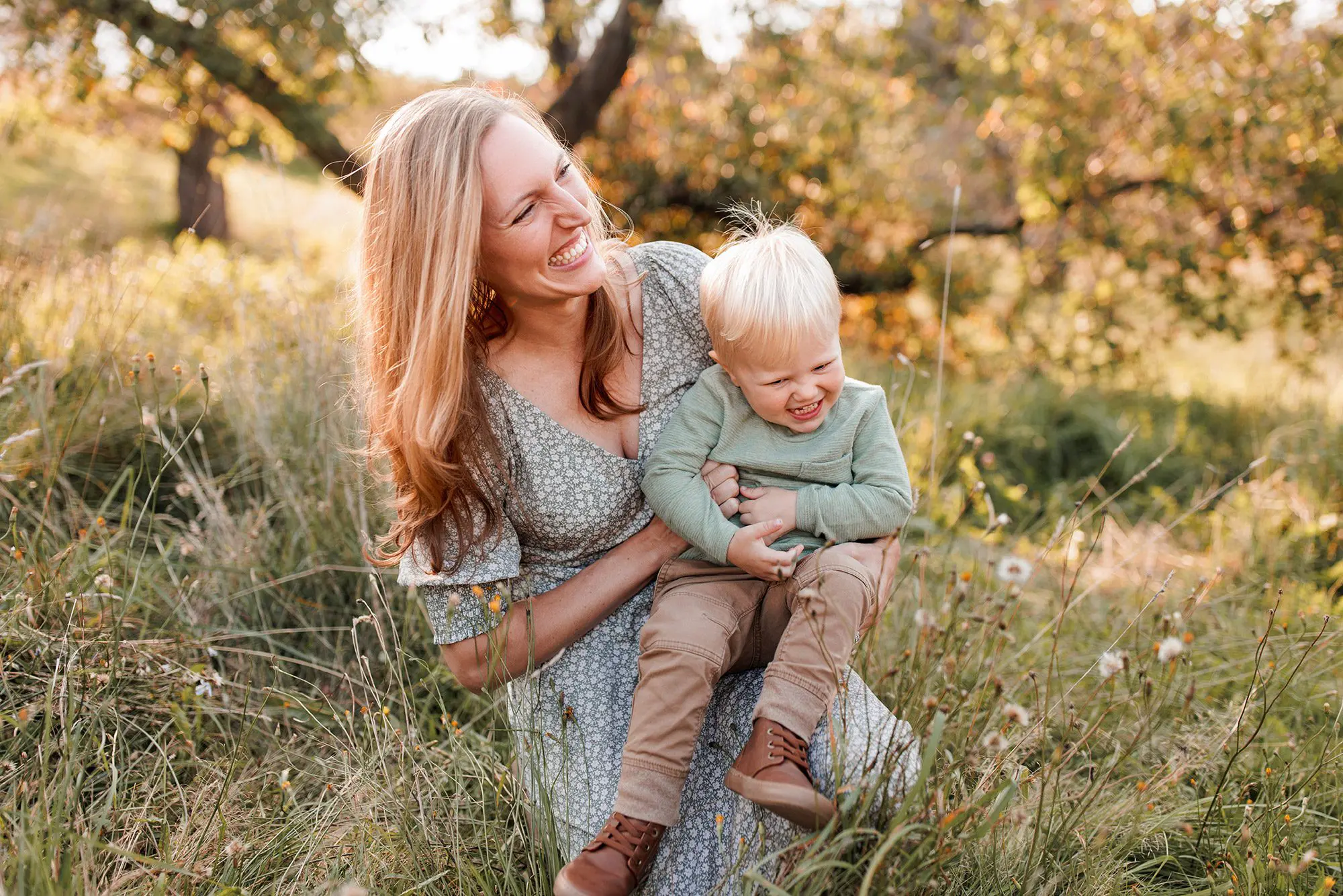 The best family photos location in Boston: The Arnold Arboretum - mom and little boy in front of interesting tree in the arboretum on peter's hill