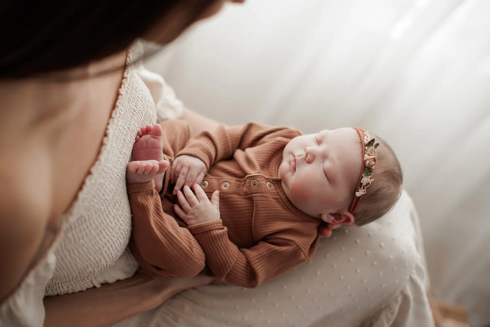 Newborn Photography Outfit - baby in blush one piece with mom holding in her lap