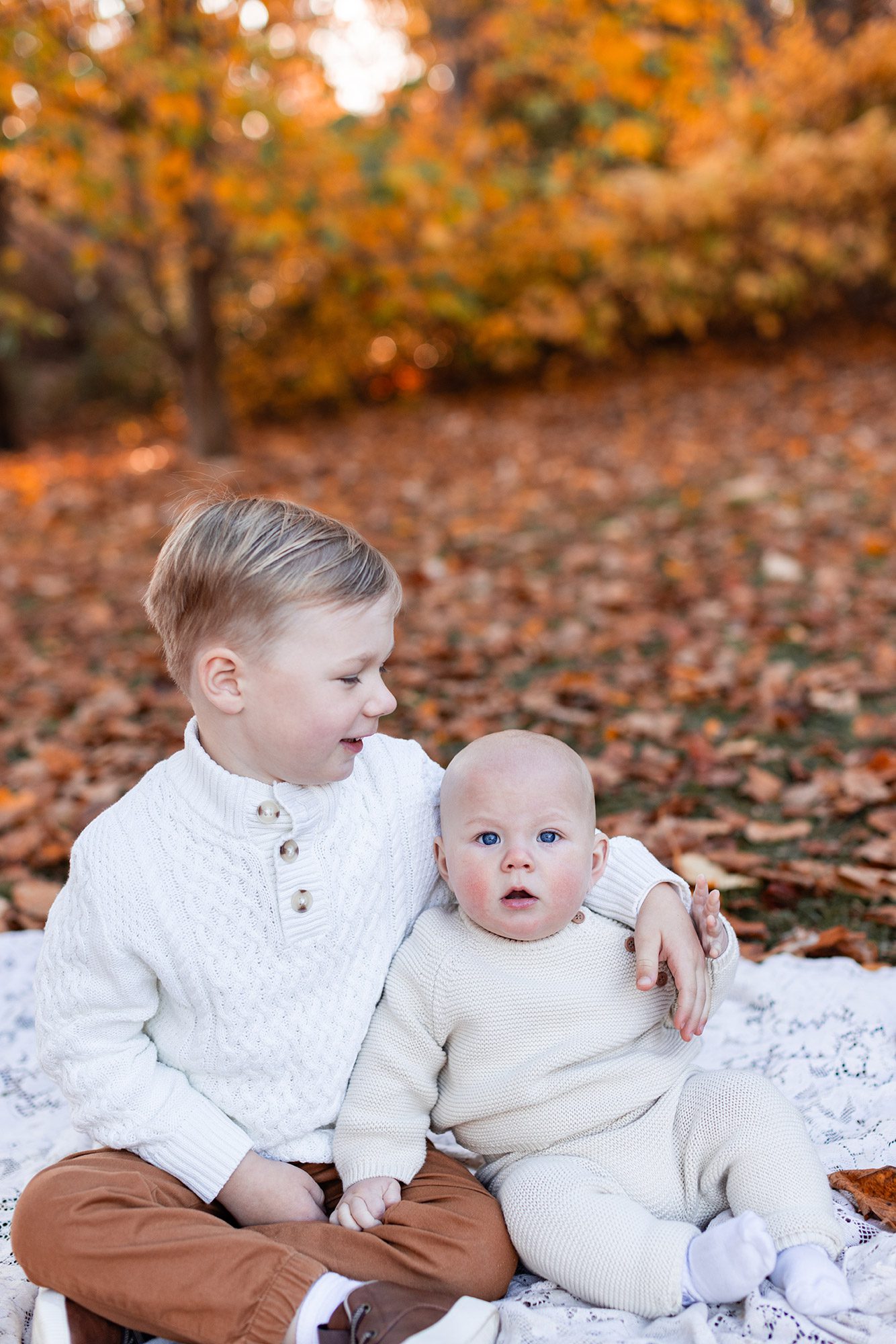 Boston Fall Family Photos - big brother with his arm around baby