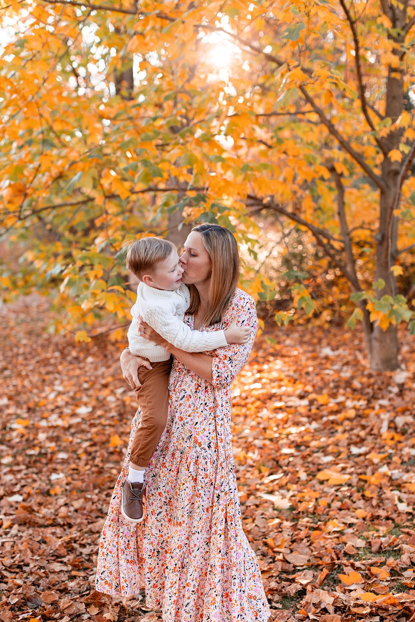 Boston Fall Family Photos - mom holding and kissing her son