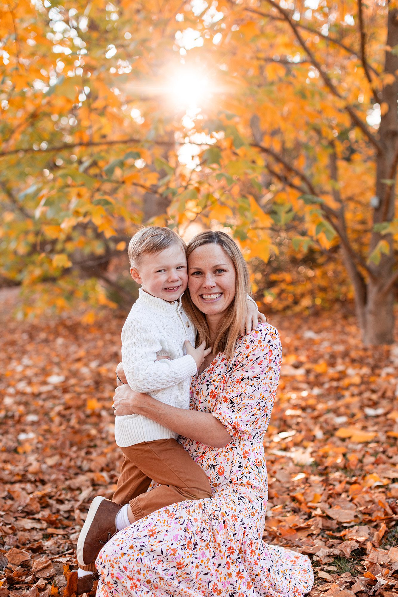Boston Fall Family Photos - mom in floral dress with oldest son