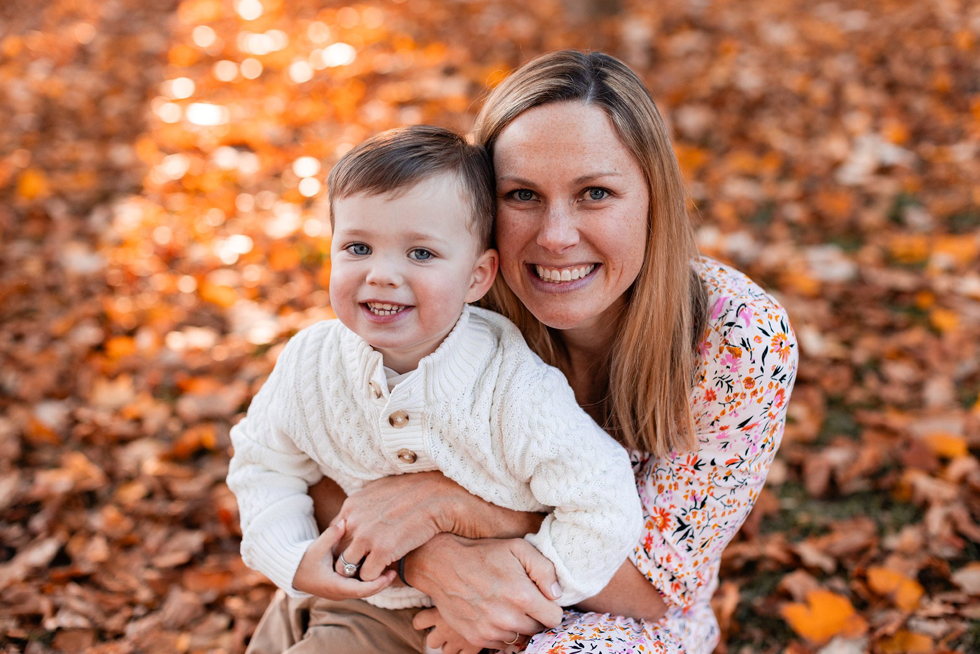 Boston Fall Family Photos - mama snuggling toddler boy in the leaves