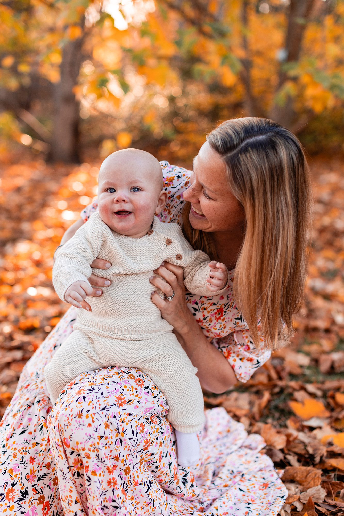 Boston Fall Family Photos - mom in floral dress holding baby