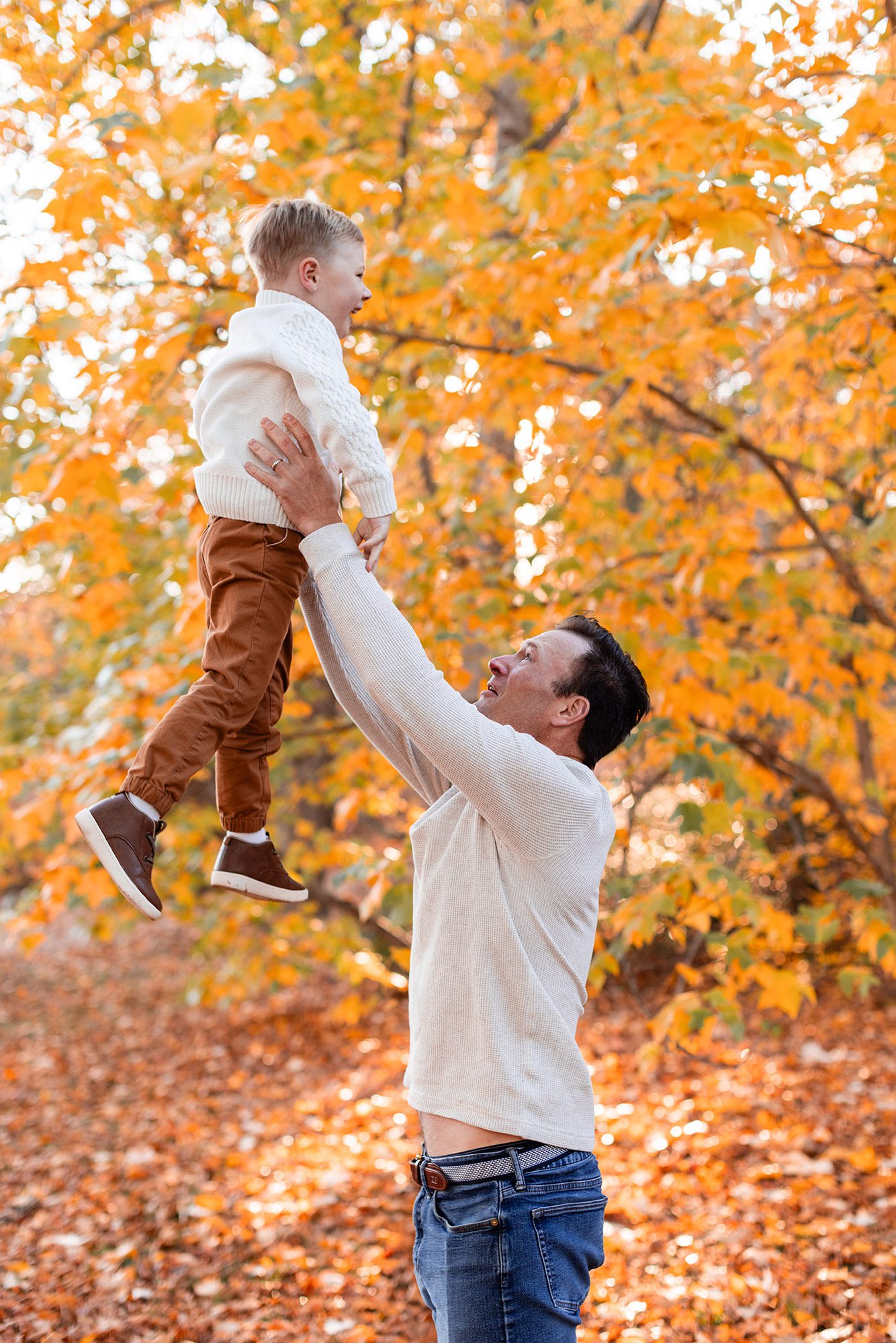 Boston Fall Family Photos - dad throwing son in the air