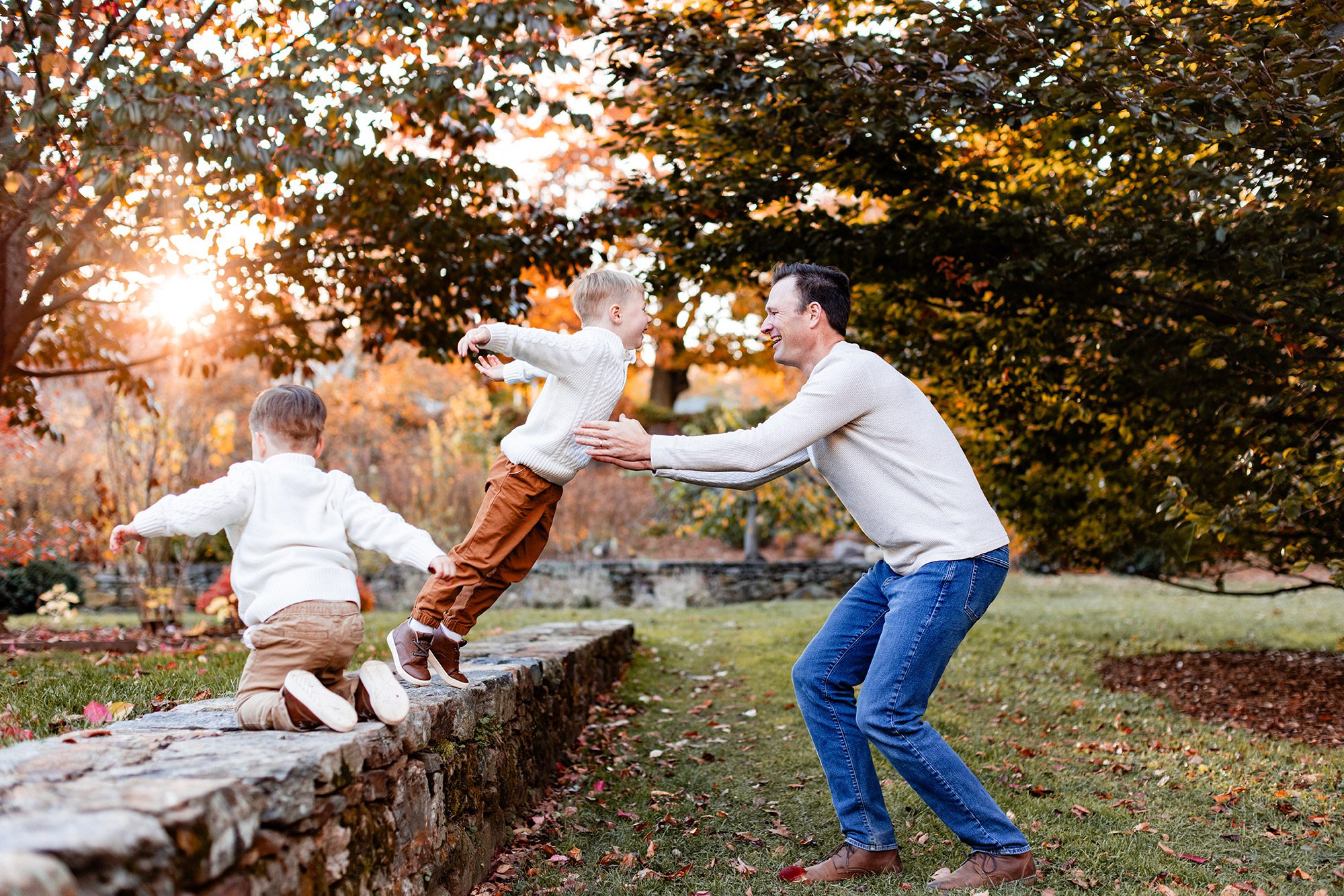 Boston Fall Family Photos - boy jumping into dad's arms