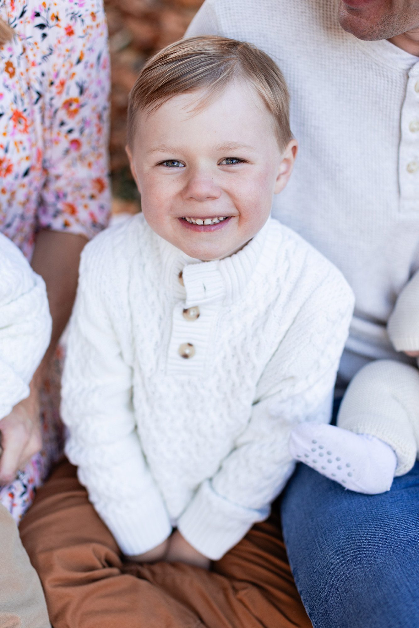 Boston Fall Family Photos - boy sitting with family smiling