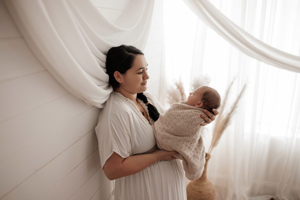 Best Newborn Photos of 2023 mom holding baby