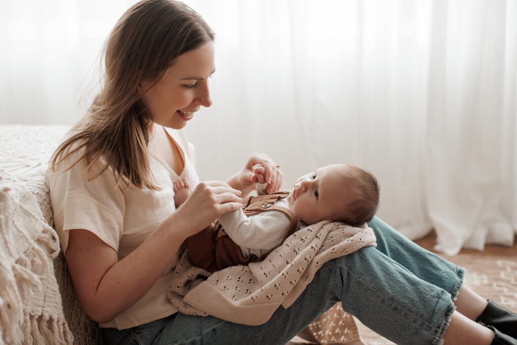 Is my baby too old for newborn photos - baby laying on mom's legs sitting down