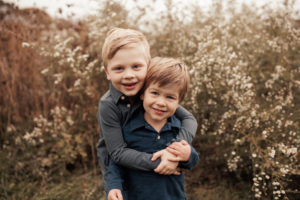 The best family photos location in Boston: The Arnold Arboretum - cloudy day still great lighting with pretty flowers behind two boys