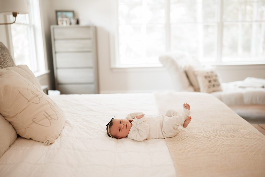 Which type of newborn photo session is best - lifestyle in home baby laying on bed