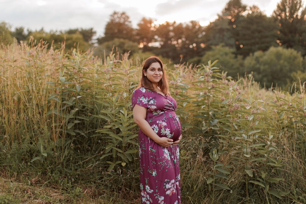 How to prepare for postpartum - expecting mom during maternity photo session in a field in Boston