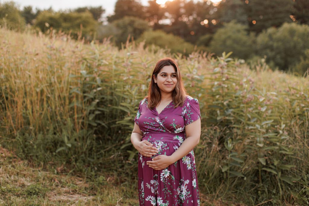 How to prepare for postpartum - pregnant mom standing in a field during golden hour