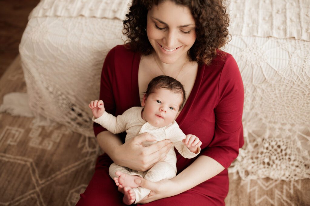 Boston newborn portraits - mom holding baby in red dress
