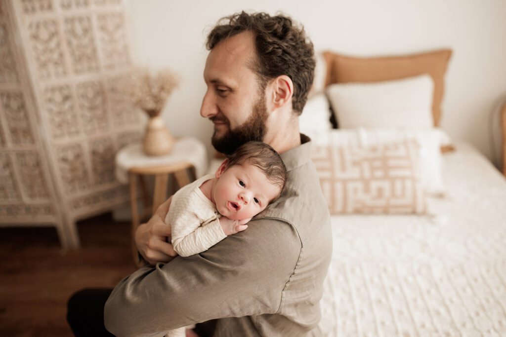 Boston newborn portraits - dad holding baby on shoulder