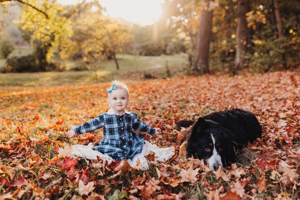 Kid friendly restaurants in roslindale - baby sitting in leaves with dog