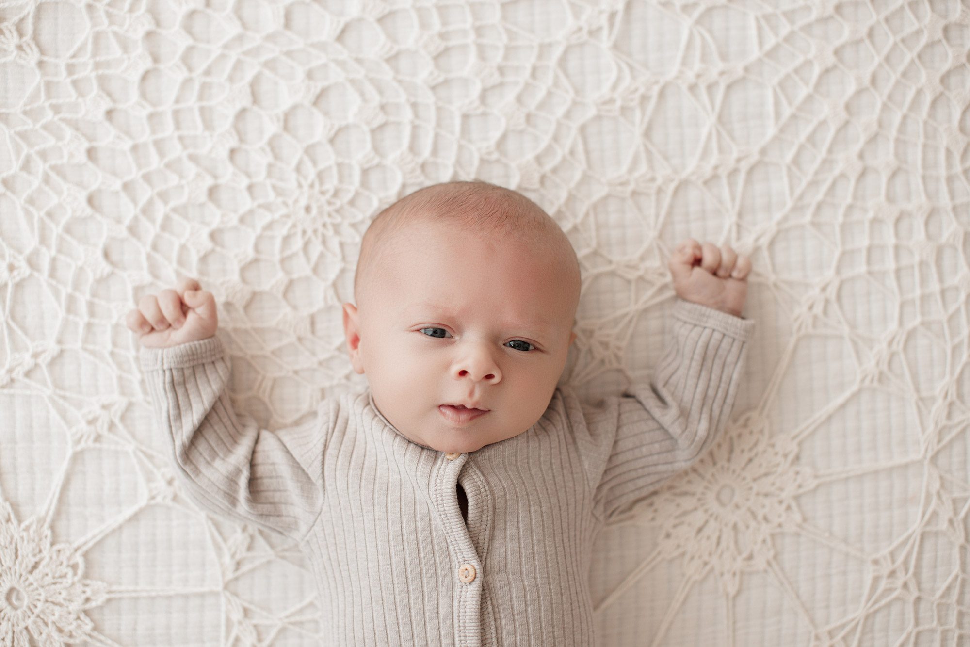 Family Photography with Newborn - baby laying on a cream lace blanket
