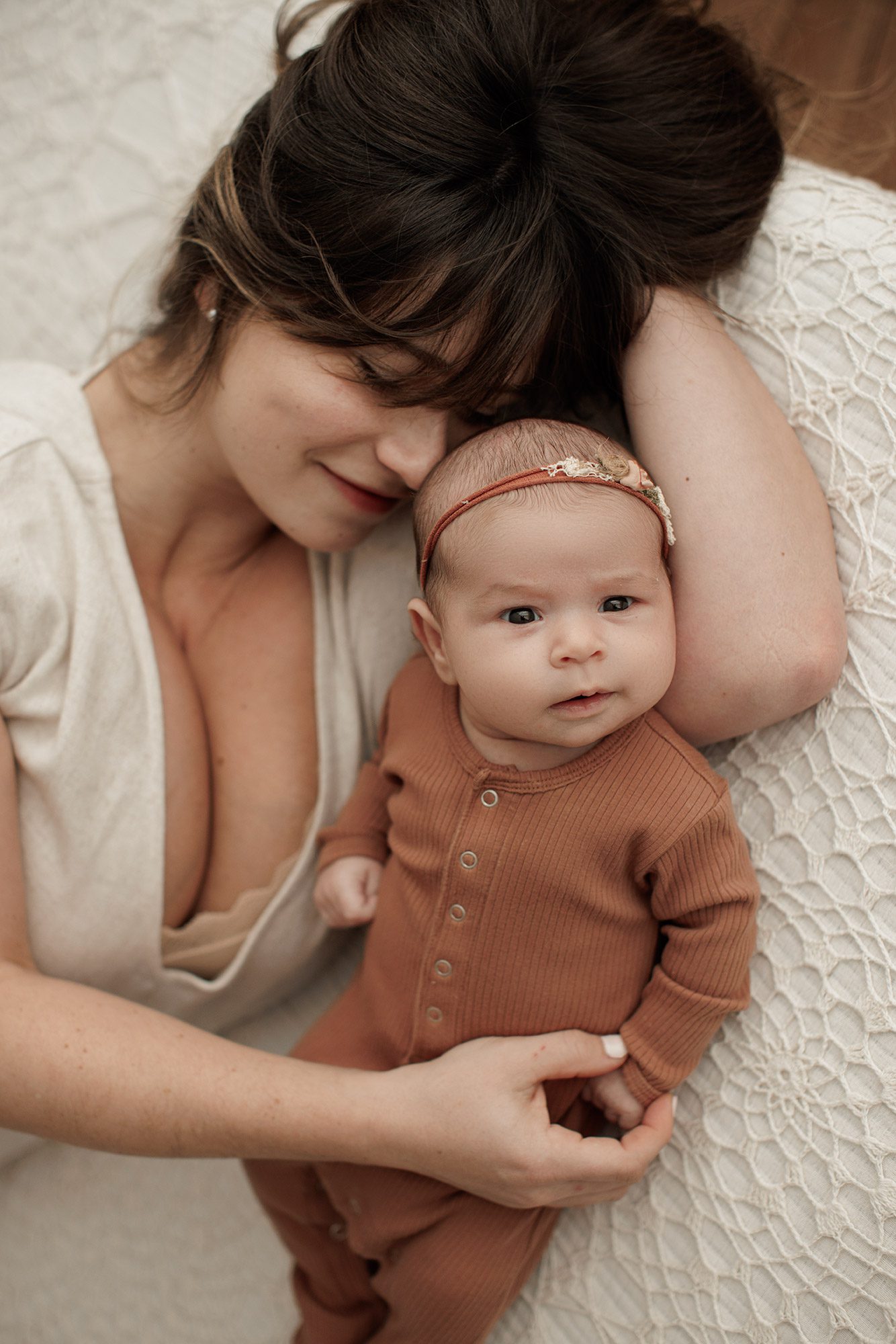 Favorite Newborn Photography Poses - mom and baby laying on a bed