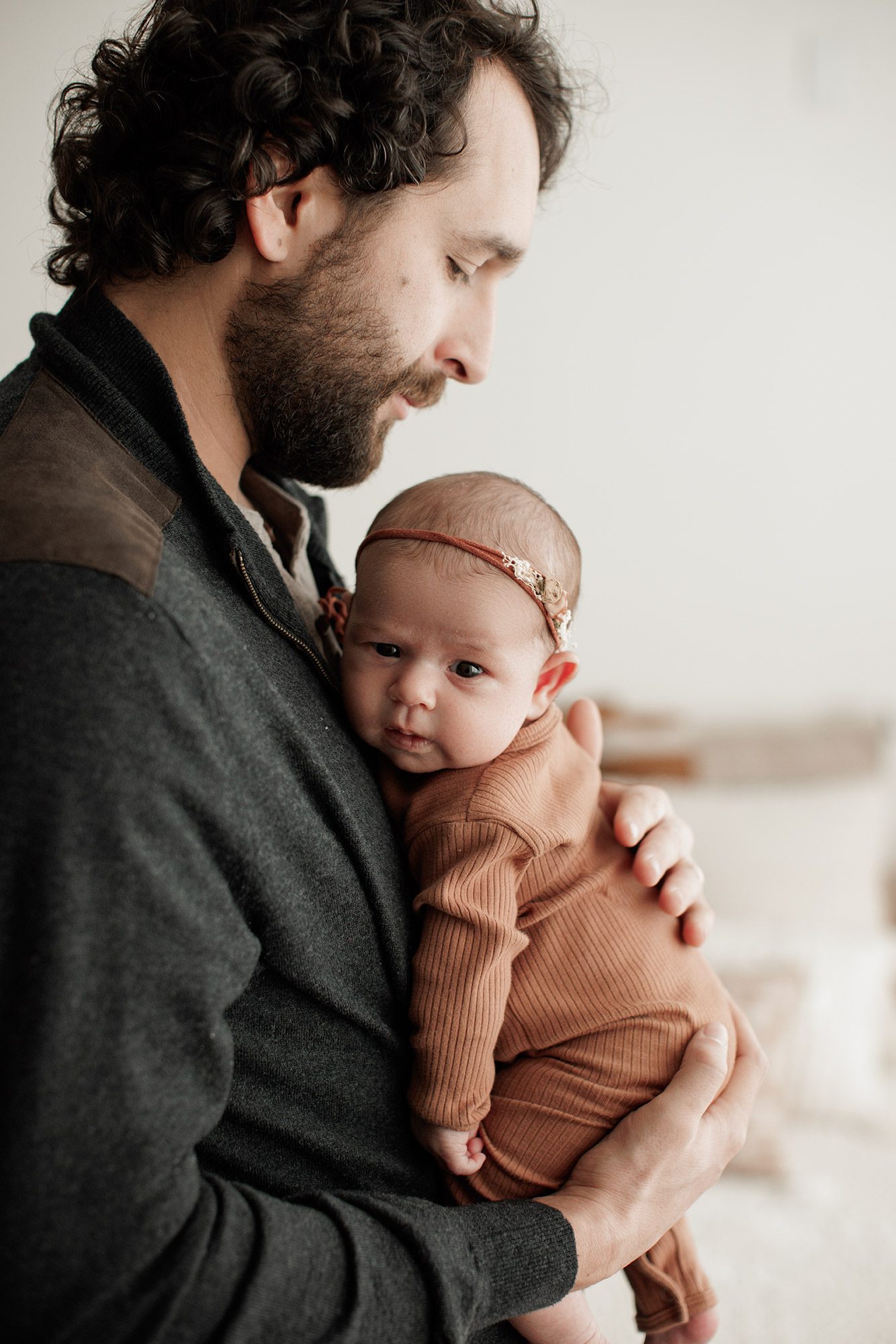 Favorite Newborn Photography Poses - dad holding baby girl on his chest