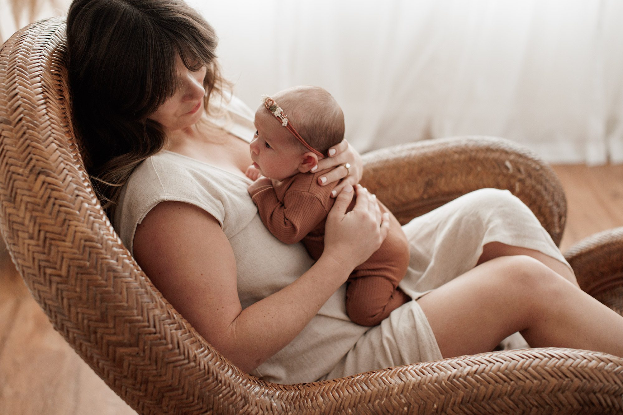 Favorite Newborn Photography Poses - baby laying on her mom on a chair
