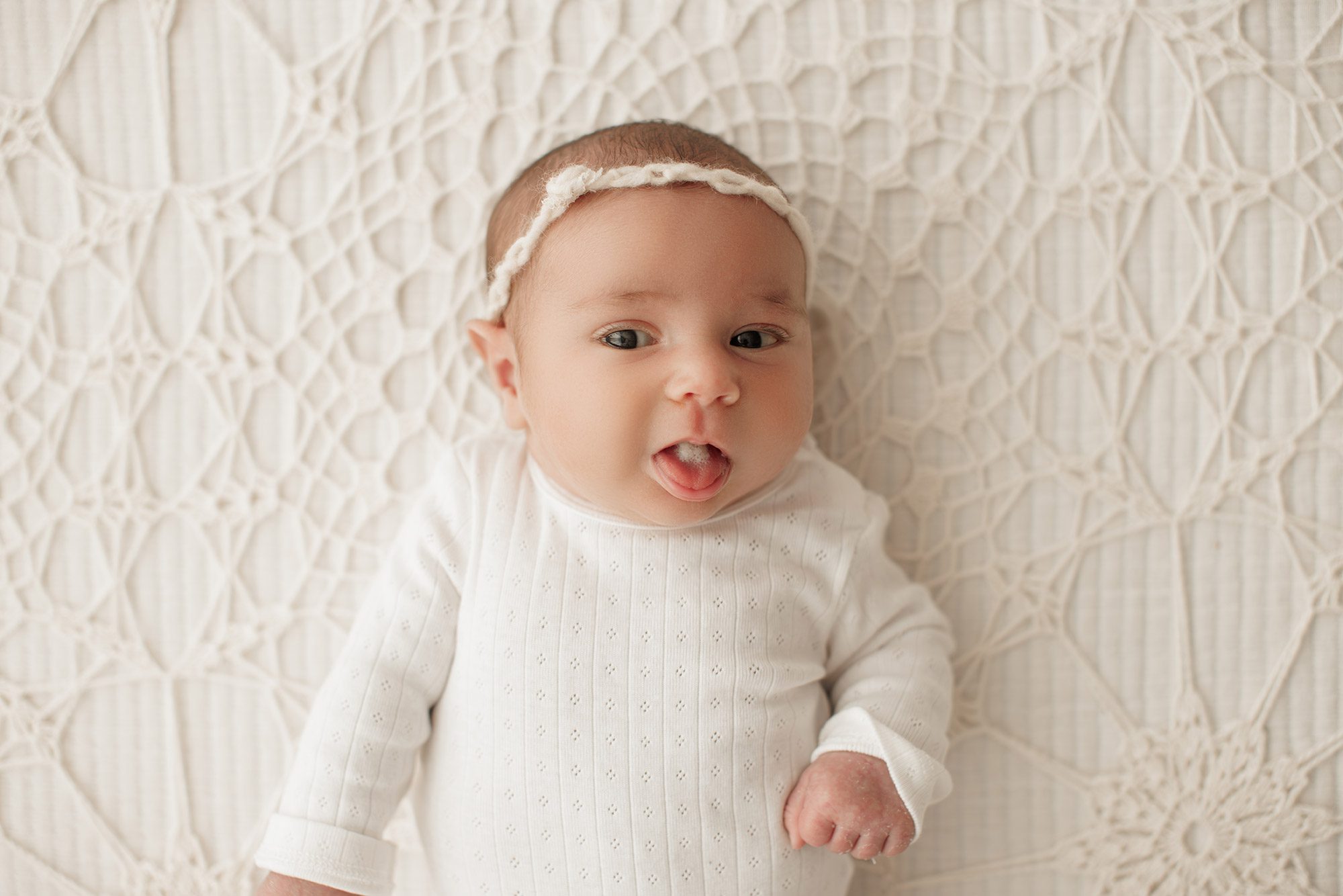 cozy minimalist newborn photoshoot Boston - baby making a silly face