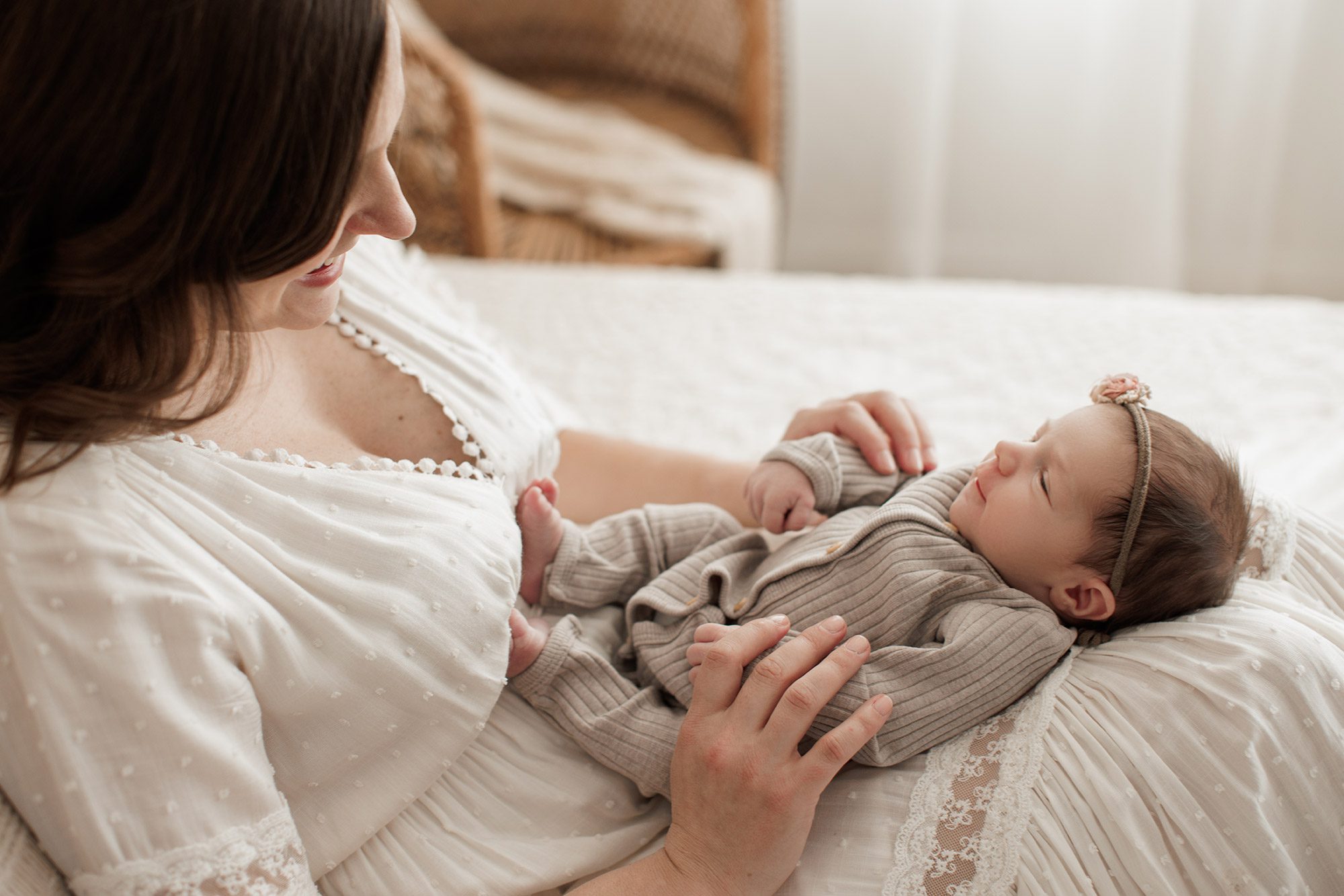 Best Location for a Newborn Photoshoot - baby laying in mom's lap
