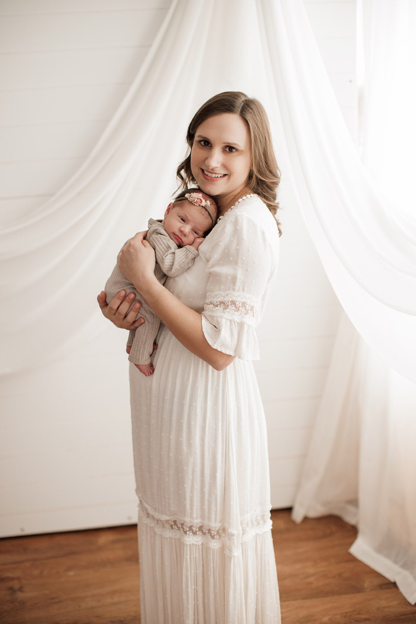Best Location for a Newborn Photoshoot - mom holding baby girl on her chest