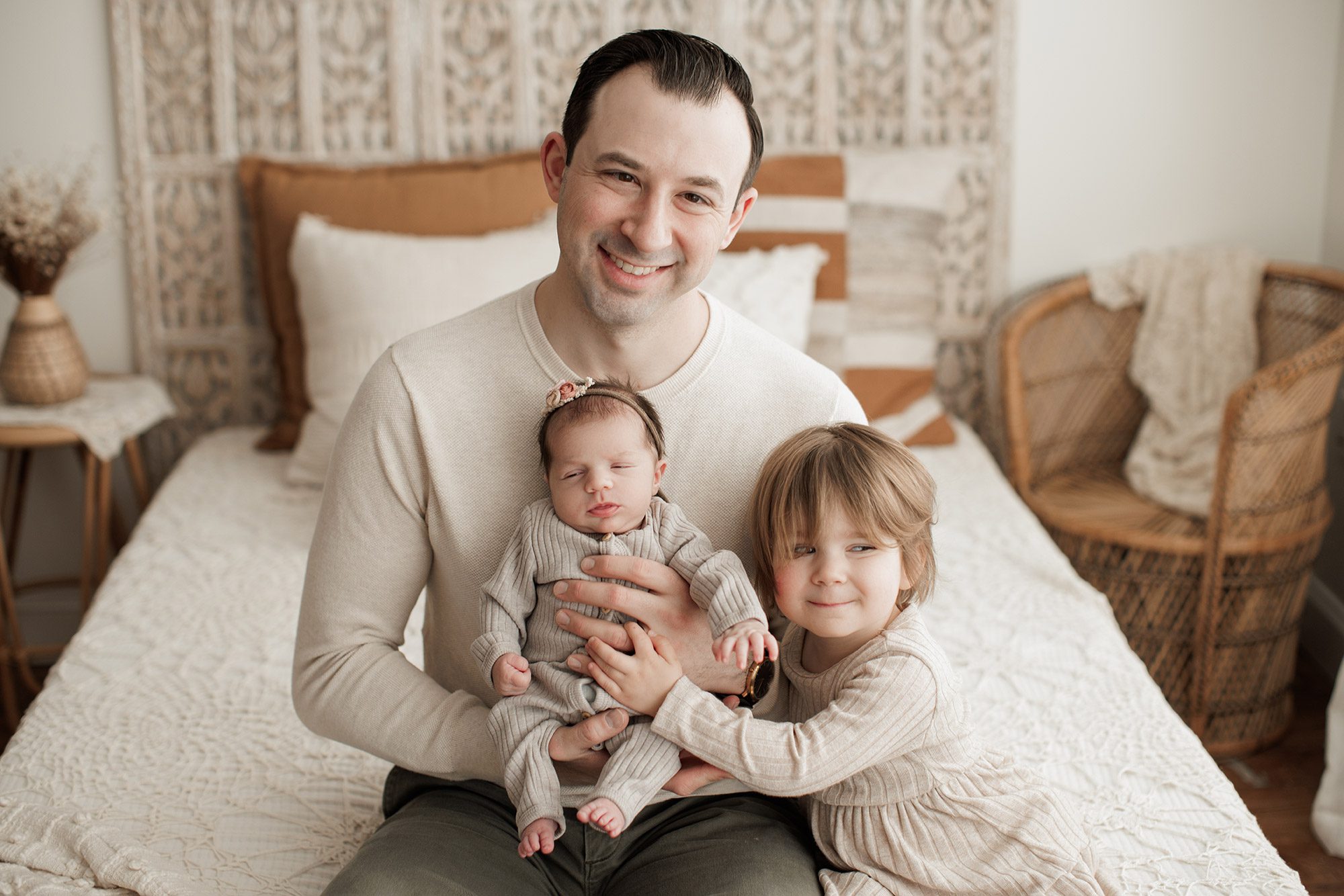 Best Location for a Newborn Photoshoot - dad holding baby girl and toddler snuggling