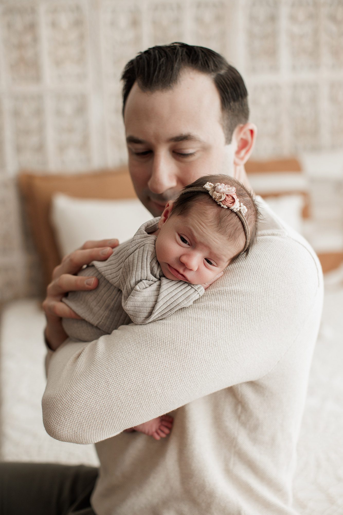Best Location for a Newborn Photoshoot - dad with baby girl on his shoulder