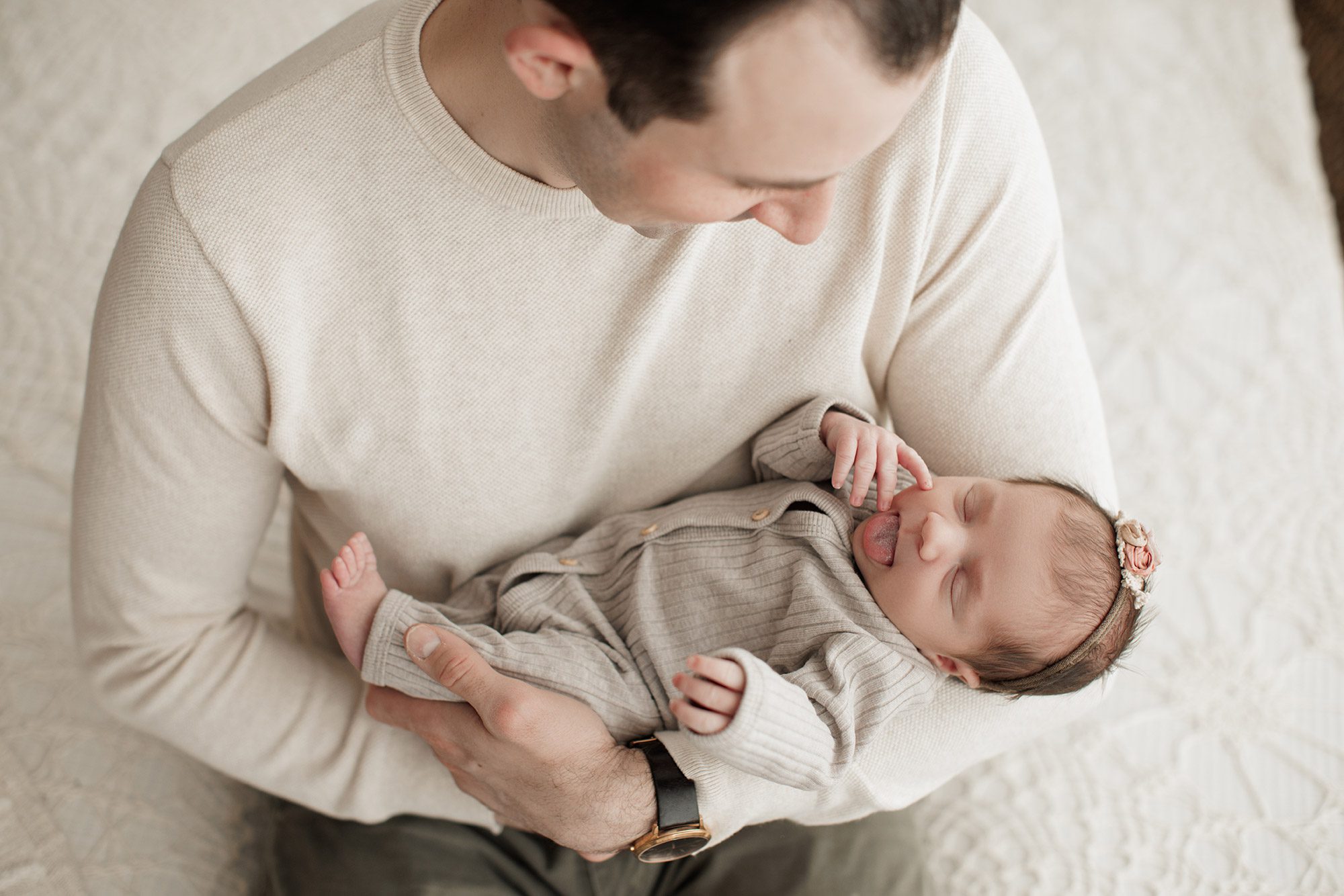 Best Location for a Newborn Photoshoot - dad holding baby girl in arms