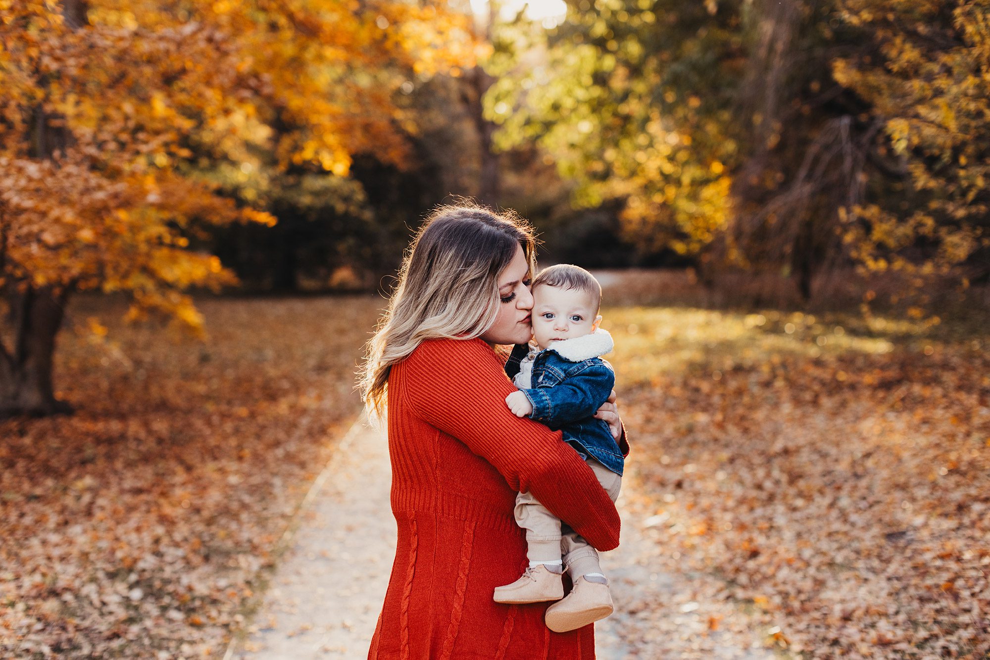 Annual Family Photos Boston Photographer - mom kissing baby with fall foliage