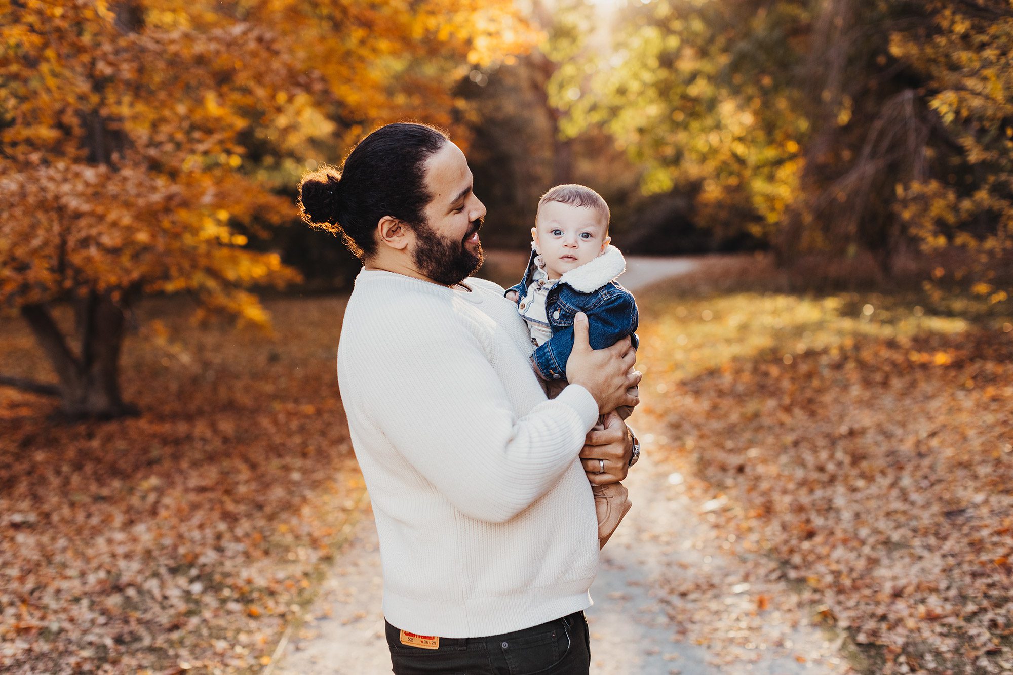 Annual Family Photos Boston Photographer - dad holding baby in fall leaves