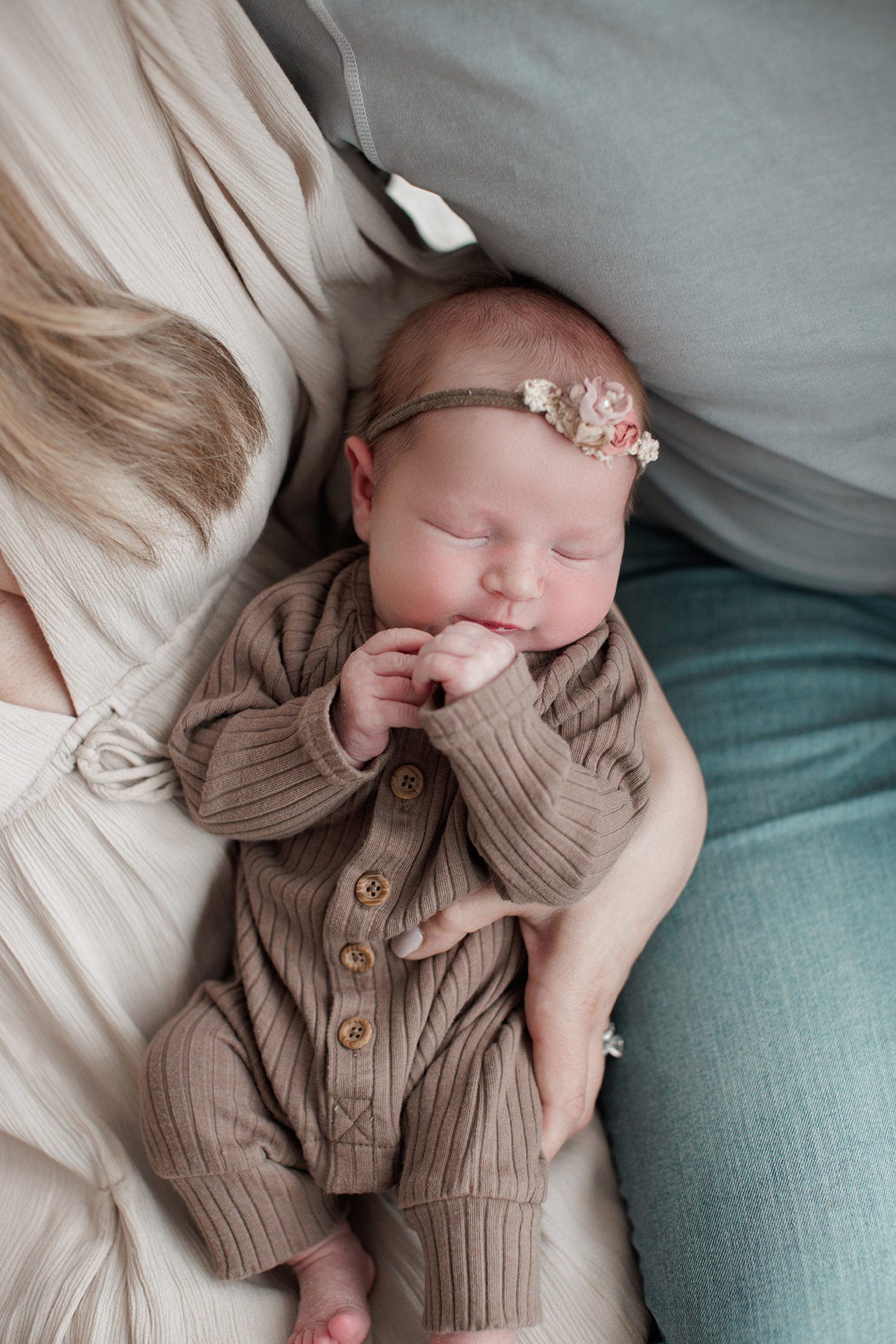 How to choose the right newborn photographer for your family - baby snuggled between her parents